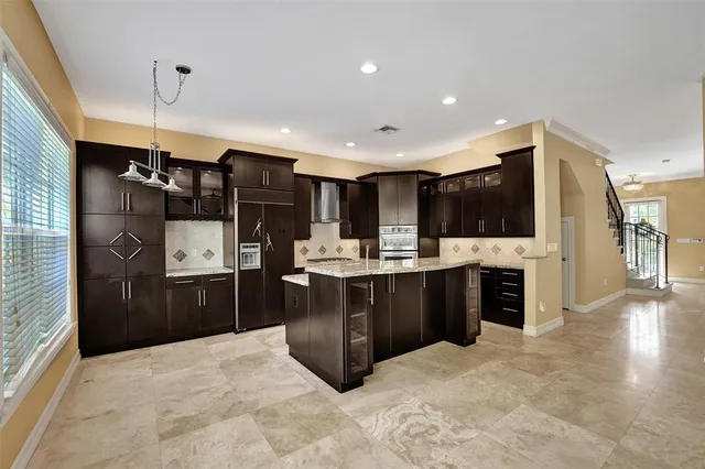 a kitchen with a stove and a refrigerator