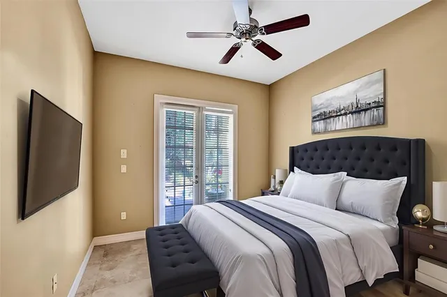 an empty room with wooden floor ceiling fan and windows