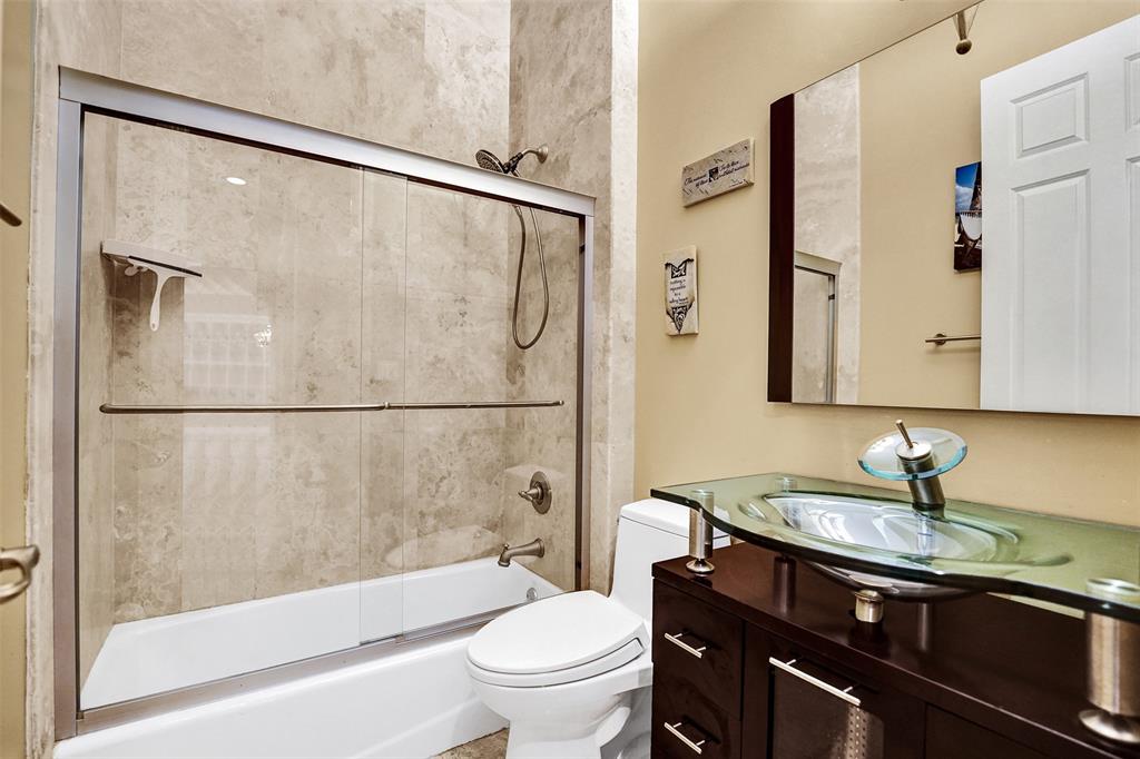 101 Northeast 21st Street Wilton Manors, FL 33305 - Photo 21 of 70 a bathroom with a granite countertop sink toilet and shower