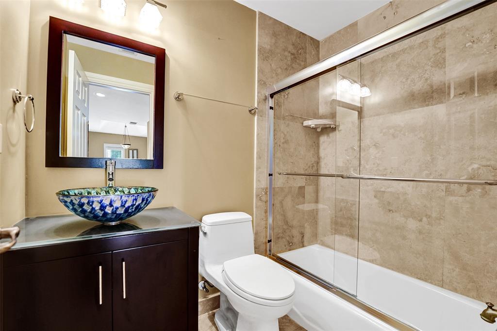 101 Northeast 21st Street Wilton Manors, FL 33305 - Photo 23 of 70 a bathroom with a toilet a sink and shower