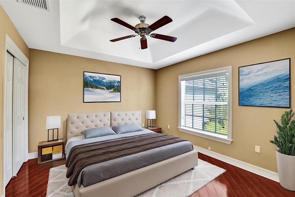 101 Northeast 21st Street Wilton Manors, FL 33305 - Photo 25 of 70 a bedroom with a bed and wooden floor