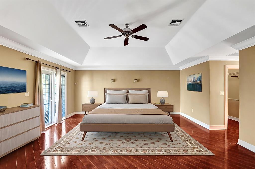 101 Northeast 21st Street Wilton Manors, FL 33305 - Photo 28 of 70 a bedroom with a large bed and wooden floor