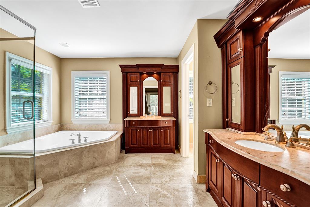 101 Northeast 21st Street Wilton Manors, FL 33305 - Photo 33 of 70 a spacious bathroom with a tub sink and mirror