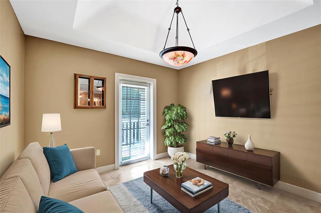 101 Northeast 21st Street Wilton Manors, FL 33305 - Photo 42 of 70 a living room with furniture and a flat screen tv