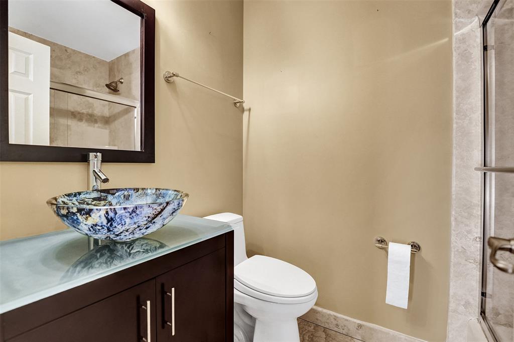 101 Northeast 21st Street Wilton Manors, FL 33305 - Photo 44 of 70 a bathroom with a granite countertop sink and a mirror