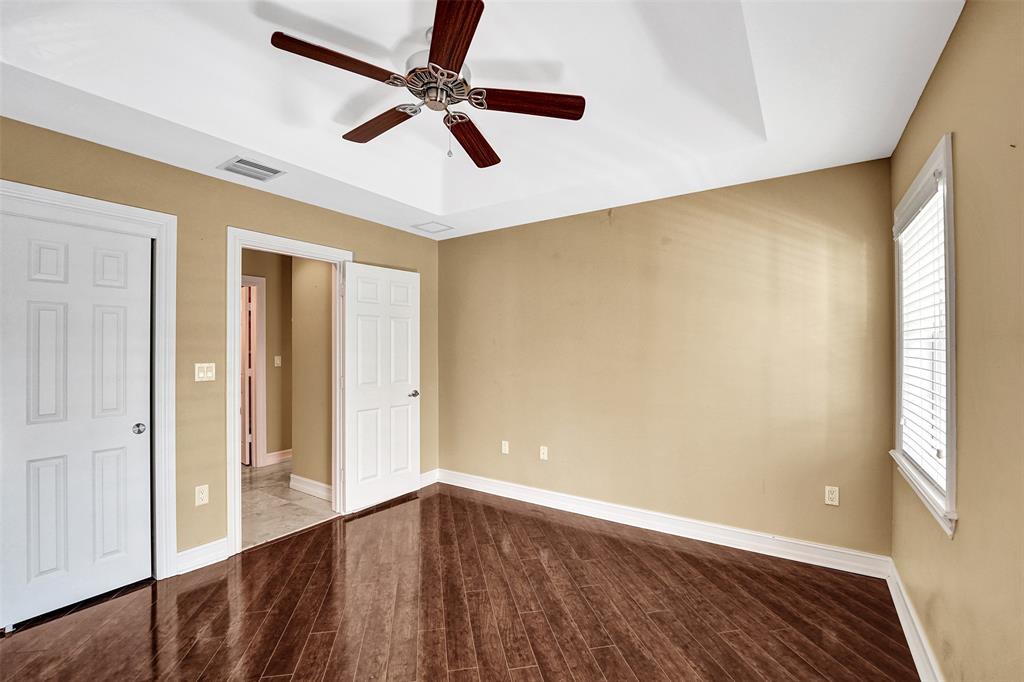 101 Northeast 21st Street Wilton Manors, FL 33305 - Photo 49 of 70 an empty room with wooden floor fan and windows