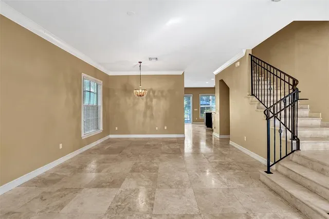 a view of a hallway with wooden floor and entryway