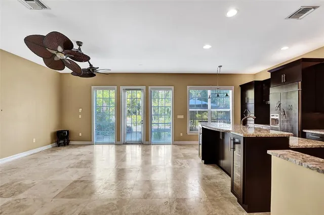 a view of a livingroom with wooden floor and a ceiling fan