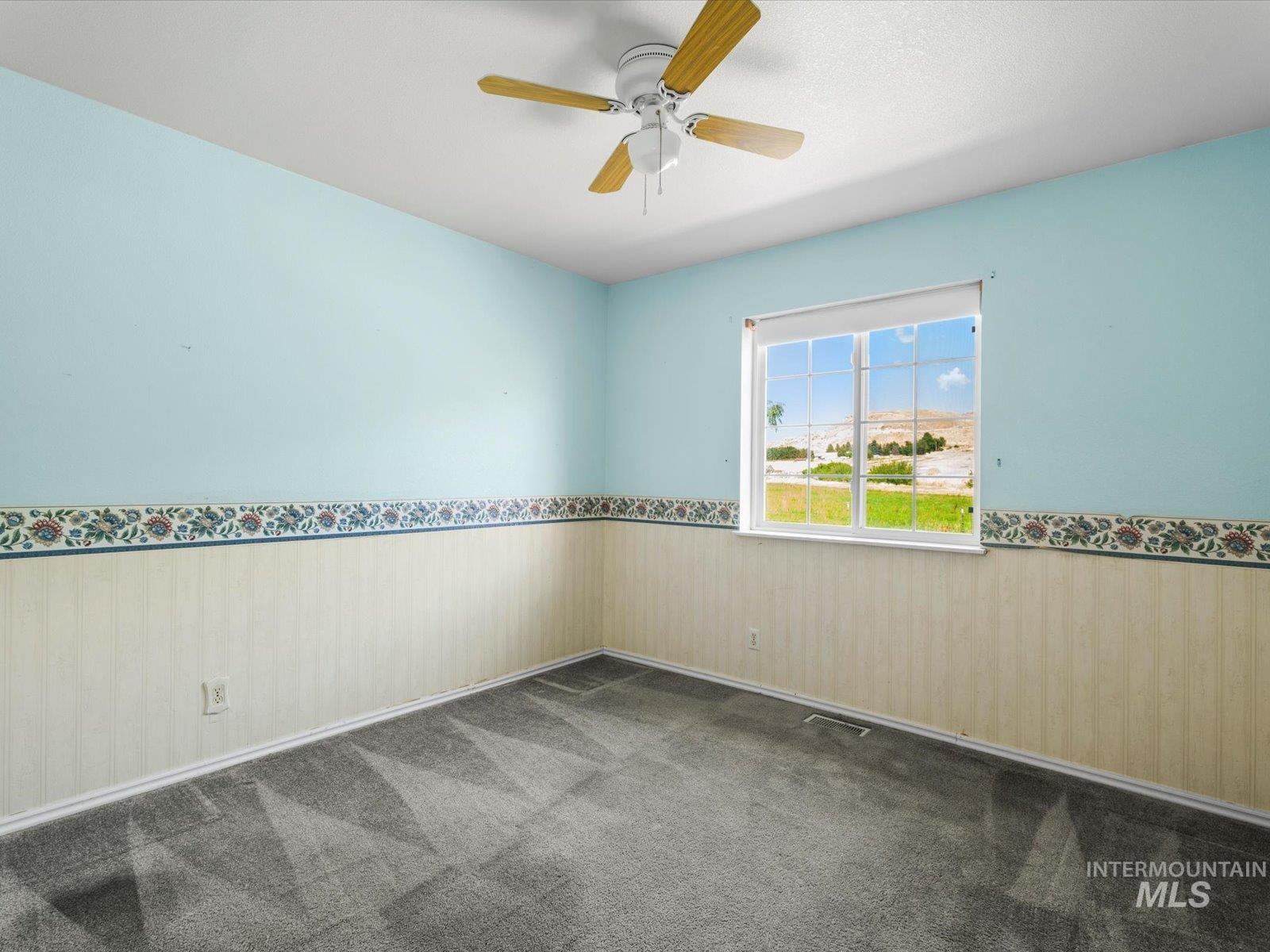 3540 Wills Road Emmett, ID 83617 - Photo 23 of 36 Room featuring a window, ceiling fan, and carpeted flooring