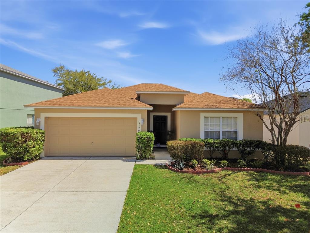 2120 Nicollett Way Leesburg, FL 34748 - Photo 1 of 22 a front view of a house with a garden