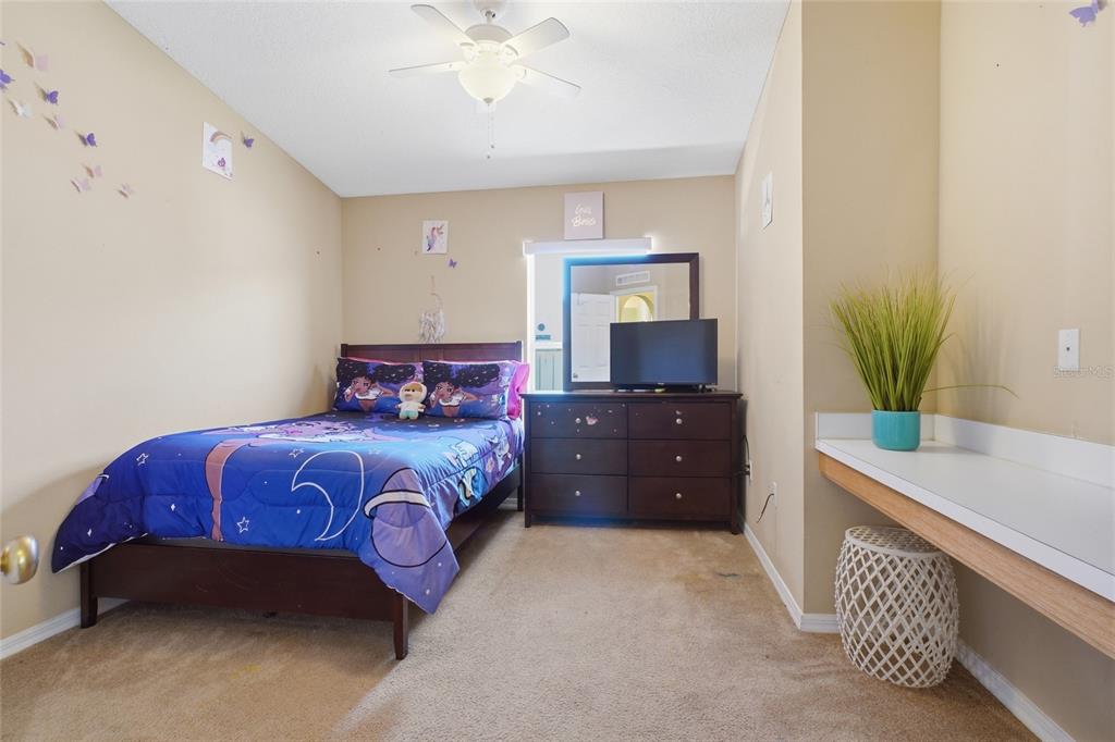 2120 Nicollett Way Leesburg, FL 34748 - Photo 11 of 22 a bedroom with a bed and a potted plant on the dresser