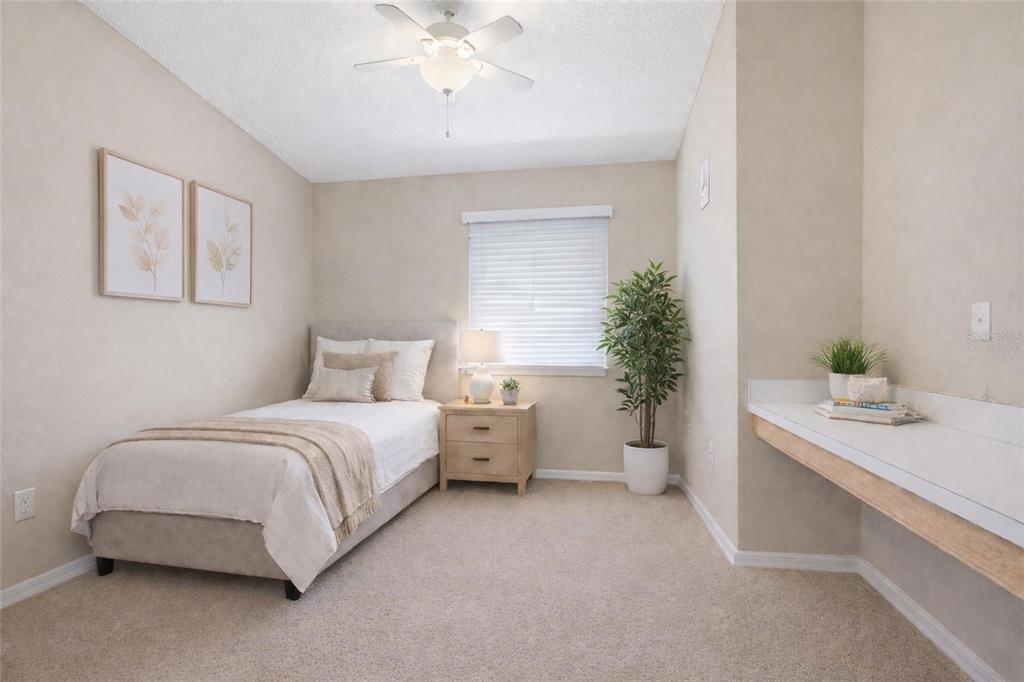 2120 Nicollett Way Leesburg, FL 34748 - Photo 12 of 22 a spacious bedroom with a bed and a chandelier