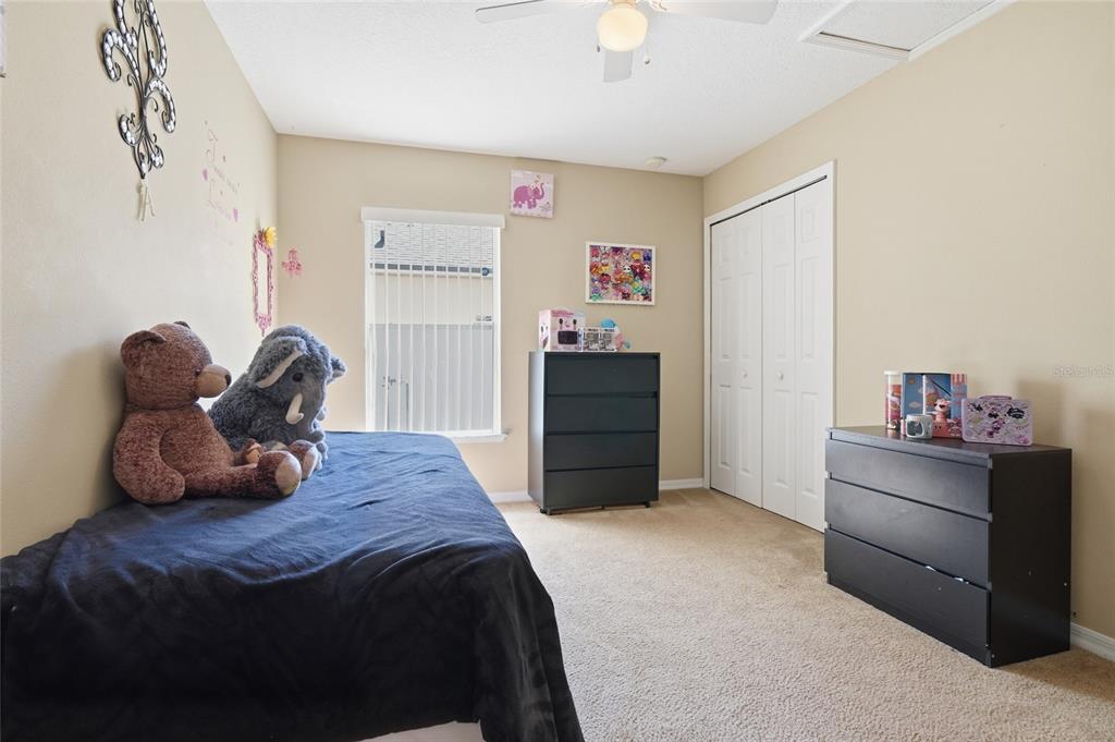 2120 Nicollett Way Leesburg, FL 34748 - Photo 13 of 22 a bedroom with a bed and cabinets