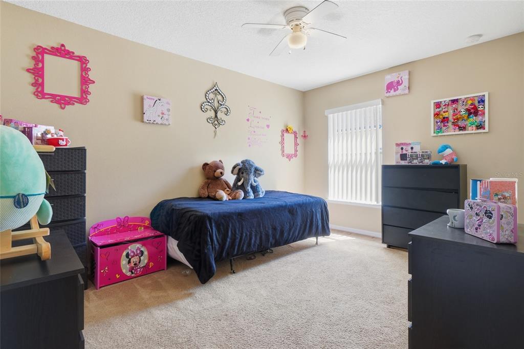 2120 Nicollett Way Leesburg, FL 34748 - Photo 14 of 22 a bedroom with a bed and a chandelier