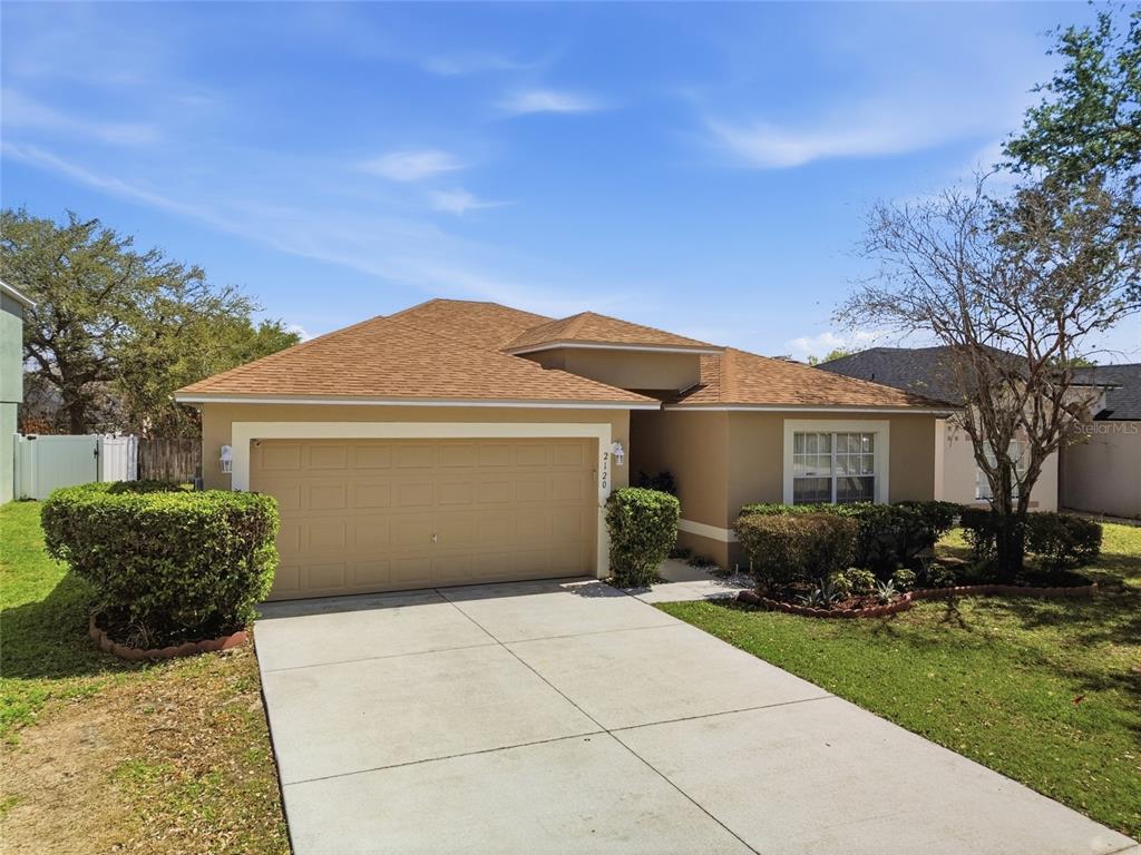 2120 Nicollett Way Leesburg, FL 34748 - Photo 18 of 22 a front view of a house with a garden