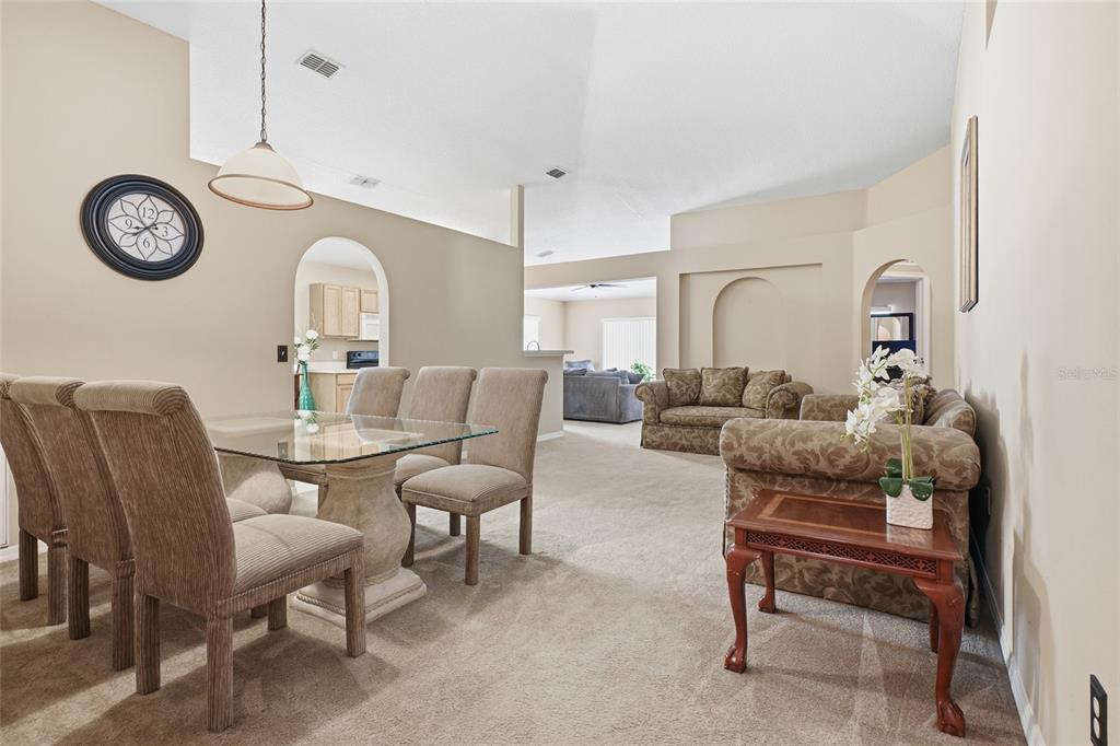 2120 Nicollett Way Leesburg, FL 34748 - Photo 2 of 22 a living room with furniture a clock and a window