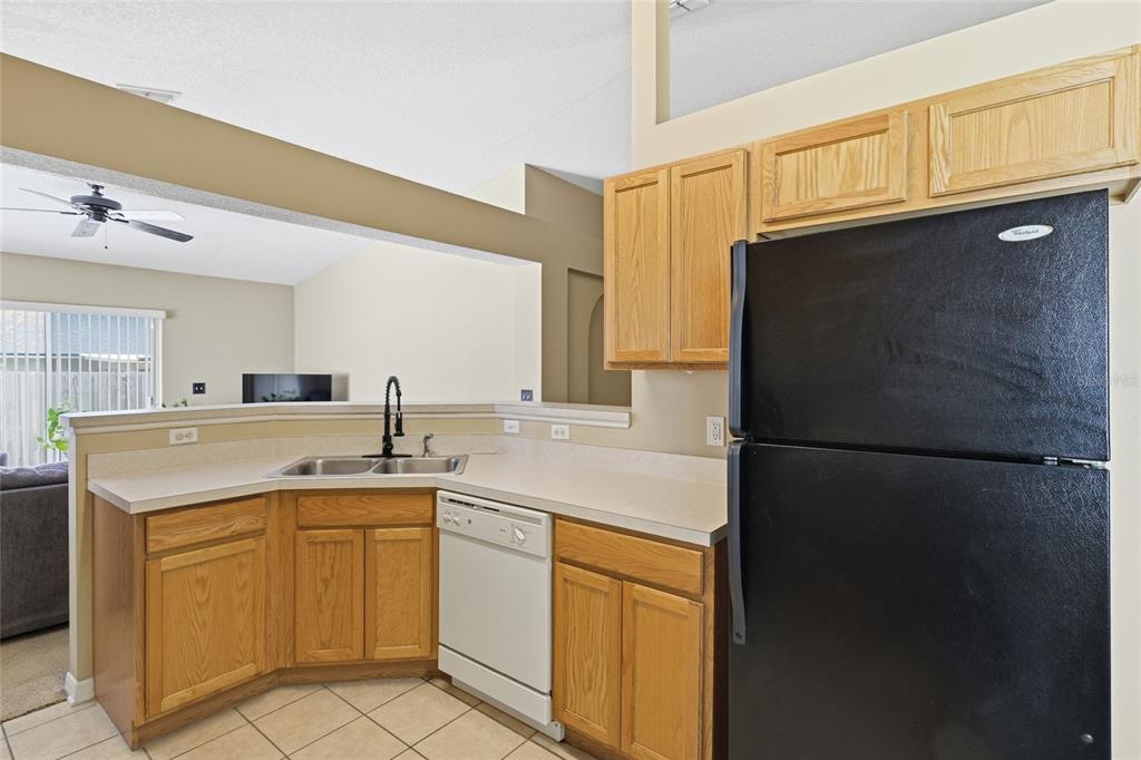 2120 Nicollett Way Leesburg, FL 34748 - Photo 4 of 22 a kitchen with a sink a refrigerator and cabinets