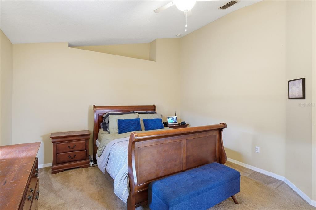 2120 Nicollett Way Leesburg, FL 34748 - Photo 8 of 22 a bedroom with a bed and a window