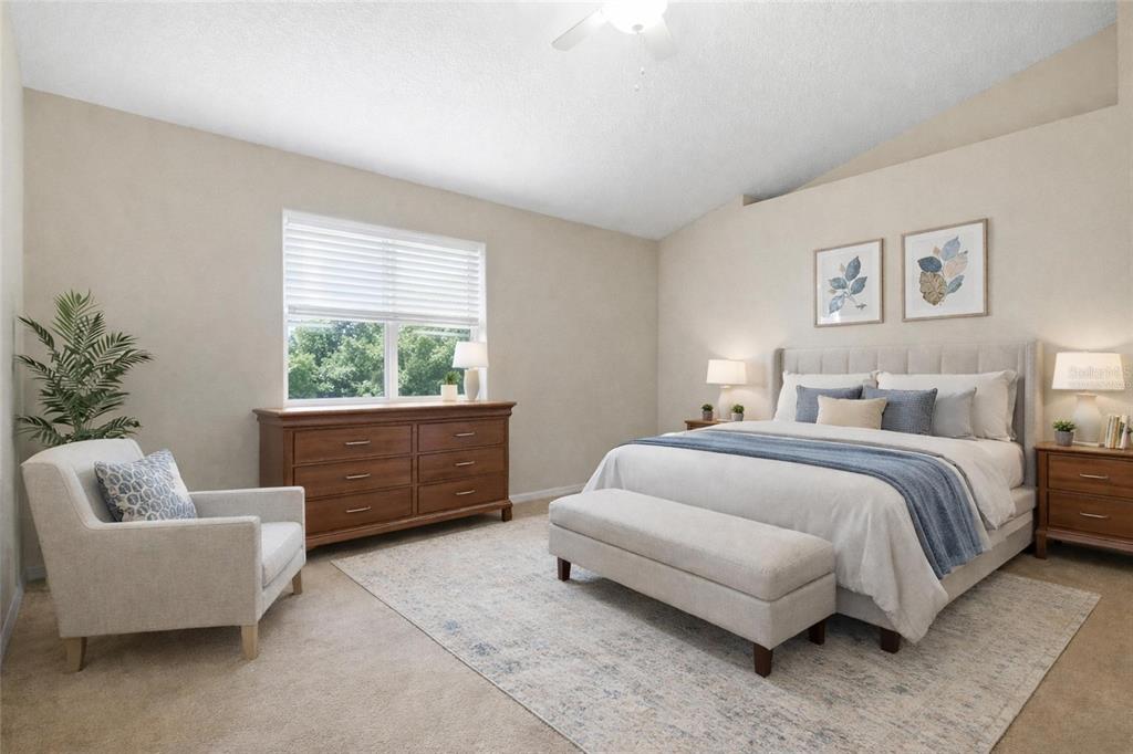 2120 Nicollett Way Leesburg, FL 34748 - Photo 9 of 22 a spacious bedroom with a bed and a couch