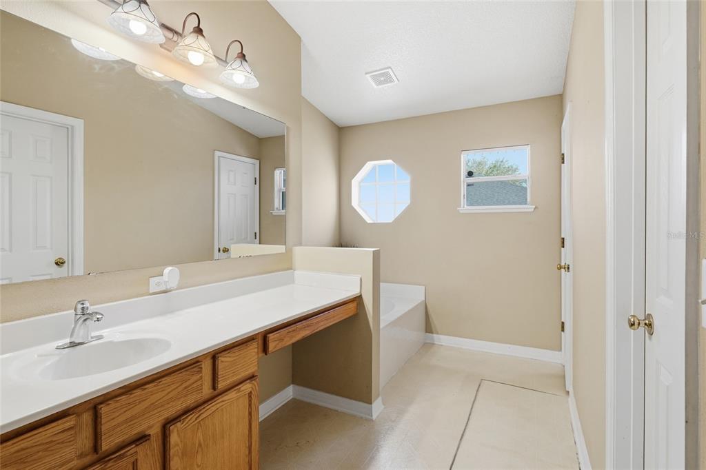 2120 Nicollett Way Leesburg, FL 34748 - Photo 10 of 22 a bathroom with a sink a light fixture and a mirror