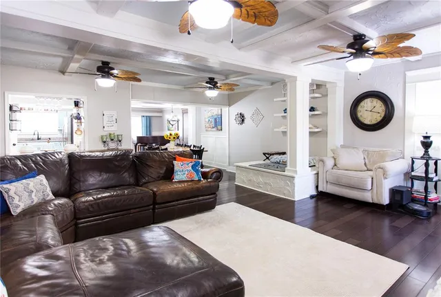 a bedroom with a large bed and a flat tv screen on dresser