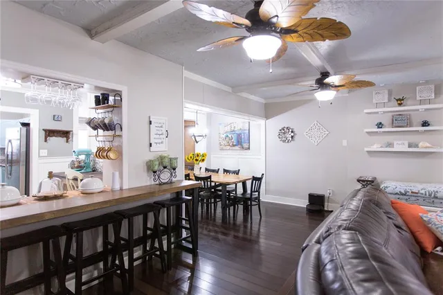 a front view of a house with a yard and potted plants