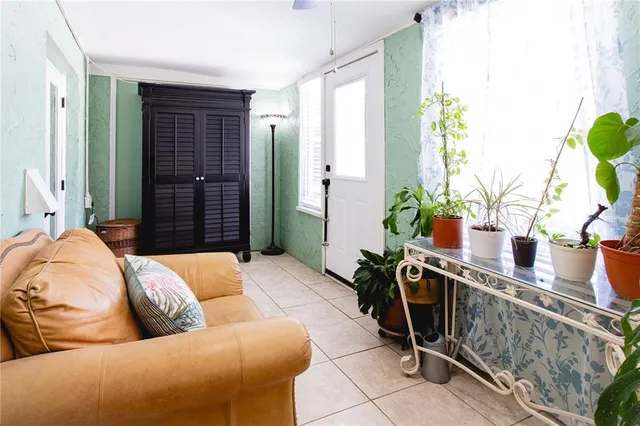 a view of a patio with table and chairs potted plants with wooden floor and fence