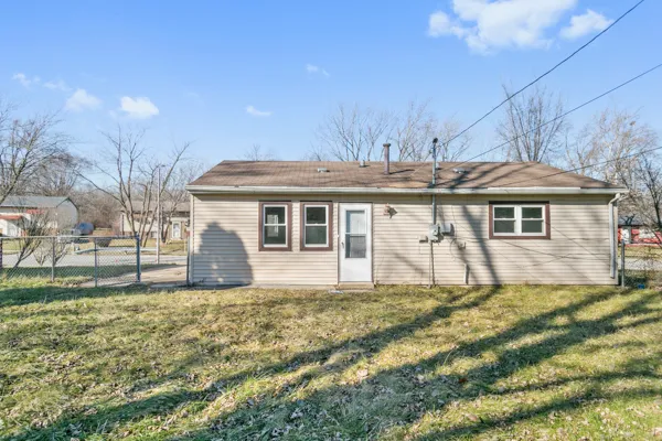 a view of a house with a yard and sitting area