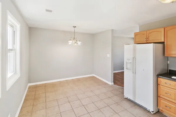 a view of a kitchen with a refrigerator cabinets and a wooden floor
