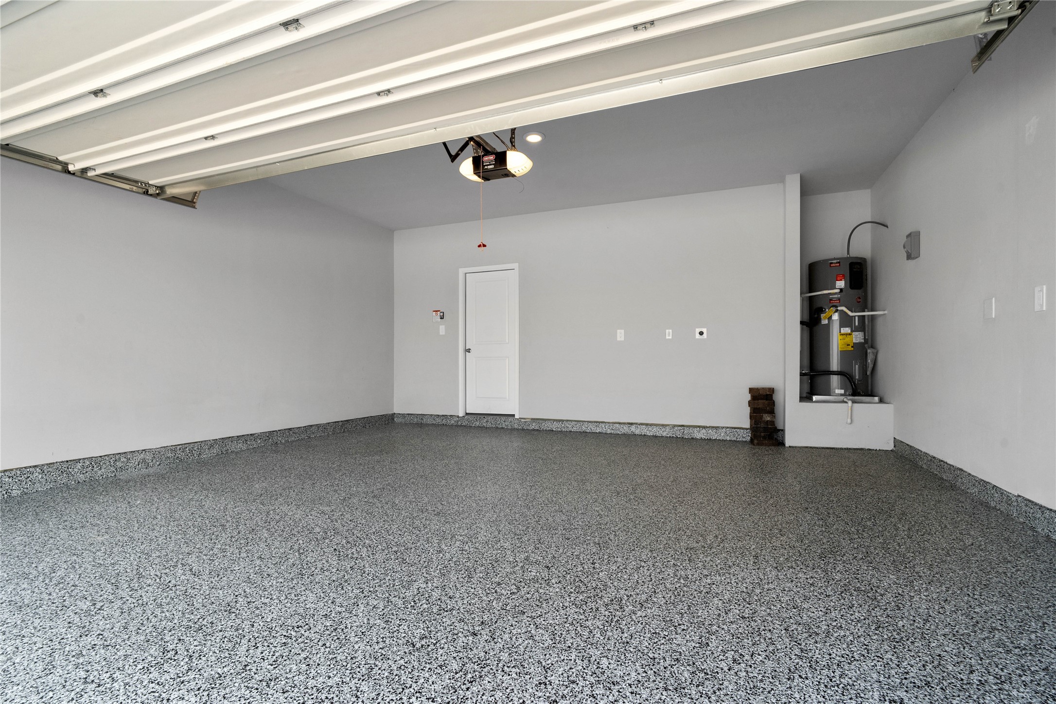 19657 Montgomery Rdg Way Montgomery, TX 77316 - Photo 42 of 49 Experience the ultimate in utility with a seamless, industrial-grade concrete coating that resists stains, chemicals, and hot-tire peel. This low-maintenance, dust-free surface ensures your garage remains as impeccable as the rest of the home for years to come.