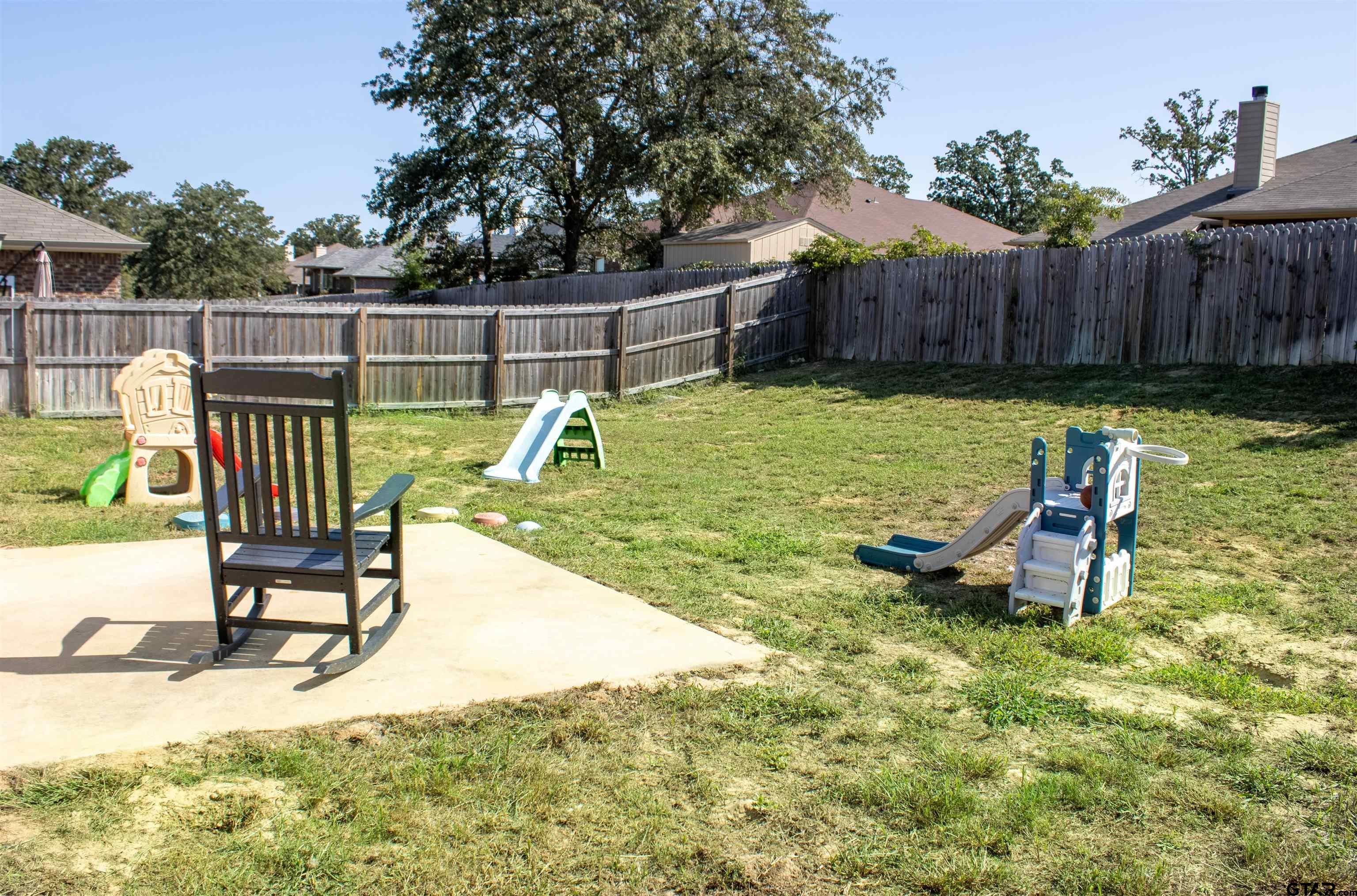 17482 Stacy Street Lindale, TX 75771 - Photo 11 of 12 a view of a swimming pool with a patio and a garden