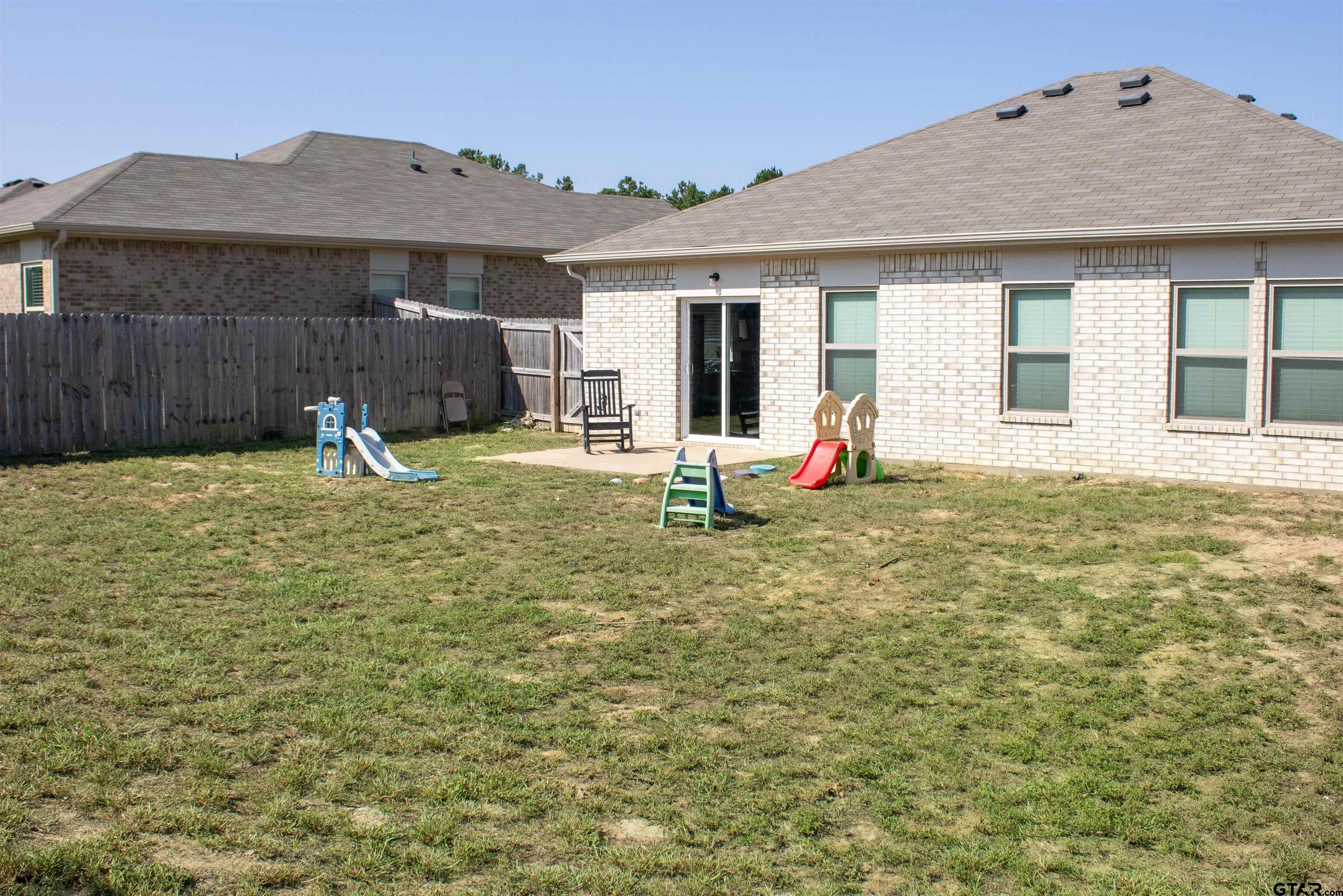 17482 Stacy Street Lindale, TX 75771 - Photo 12 of 12 a backyard of a house with yard and seating space
