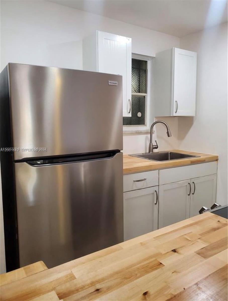 3181 Southwest 13th Street, Unit 108 Miami, FL 33145 - Photo 3 of 10 a kitchen with a refrigerator and a sink