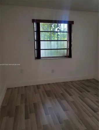 a view of wooden floor and windows in a room
