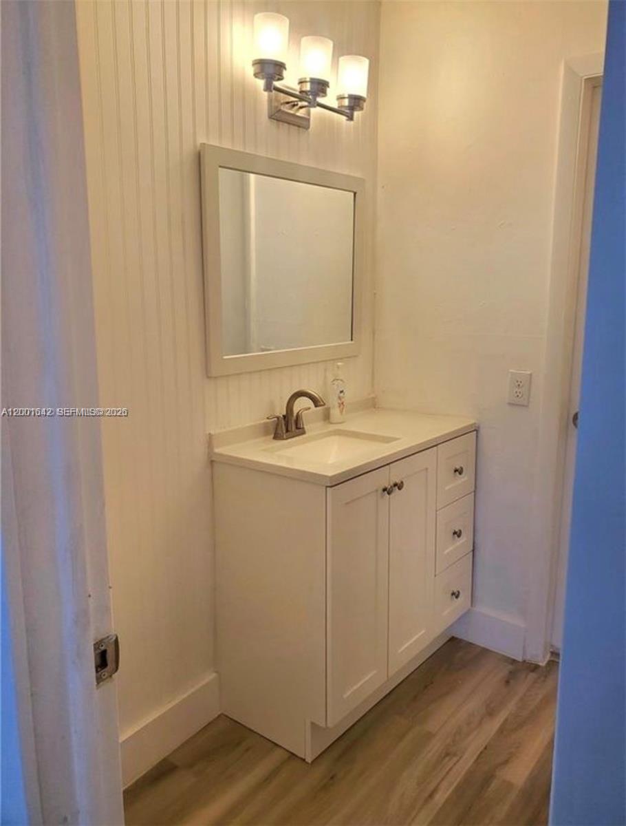 3181 Southwest 13th Street, Unit 108 Miami, FL 33145 - Photo 7 of 10 a bathroom with a sink and a mirror