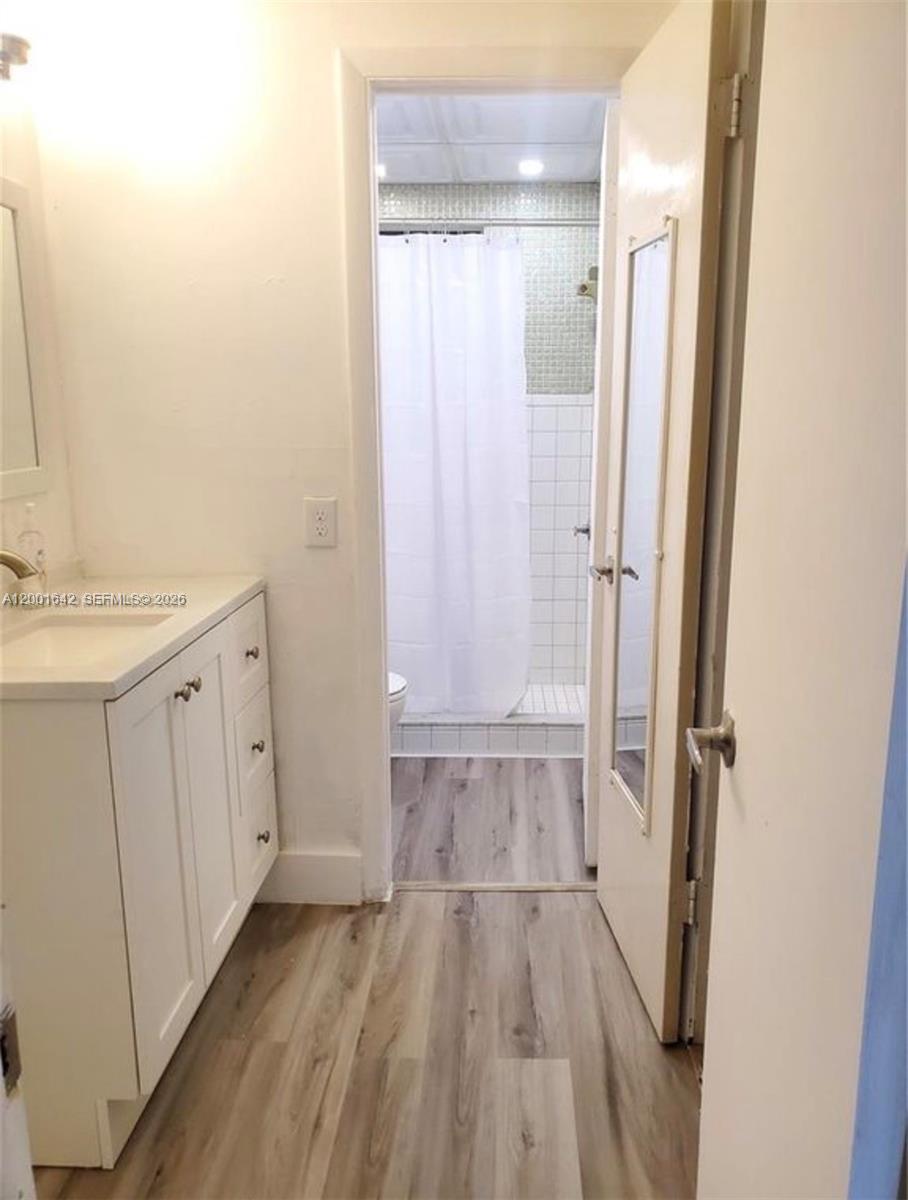 3181 Southwest 13th Street, Unit 108 Miami, FL 33145 - Photo 8 of 10 a bathroom with a sink and a mirror