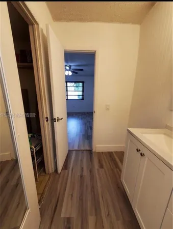a view of a hallway and wooden floor