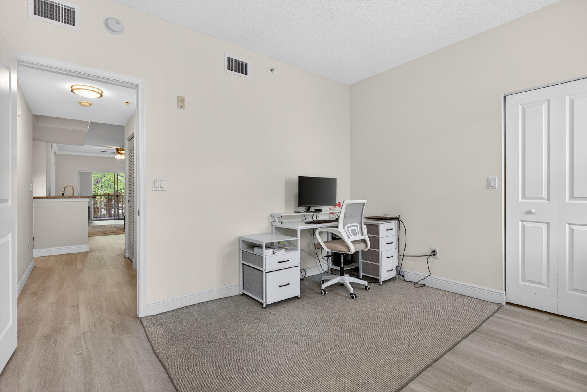 5880 West Sample Road, Unit 206 Coral Springs, FL 33067 - Photo 17 of 37 a view of a workspace with furniture and a bedroom