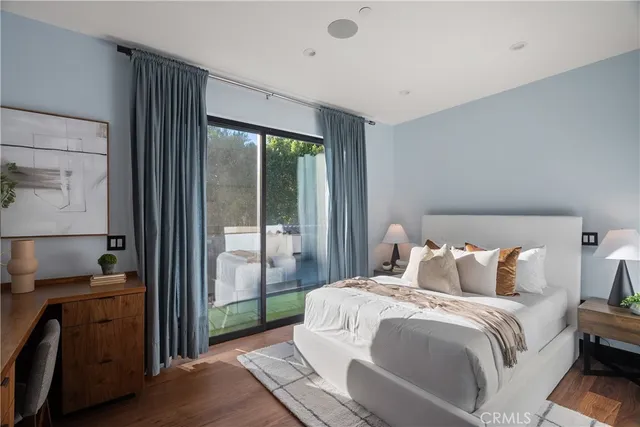 a bathroom with a white tub shower sink and mirror