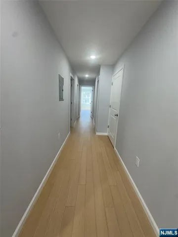 a view of hallway with wooden floor