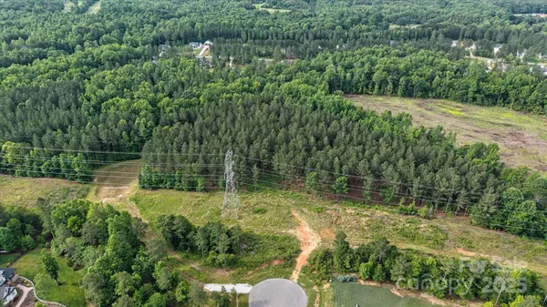 a backyard of a house with lots of green space and lake view