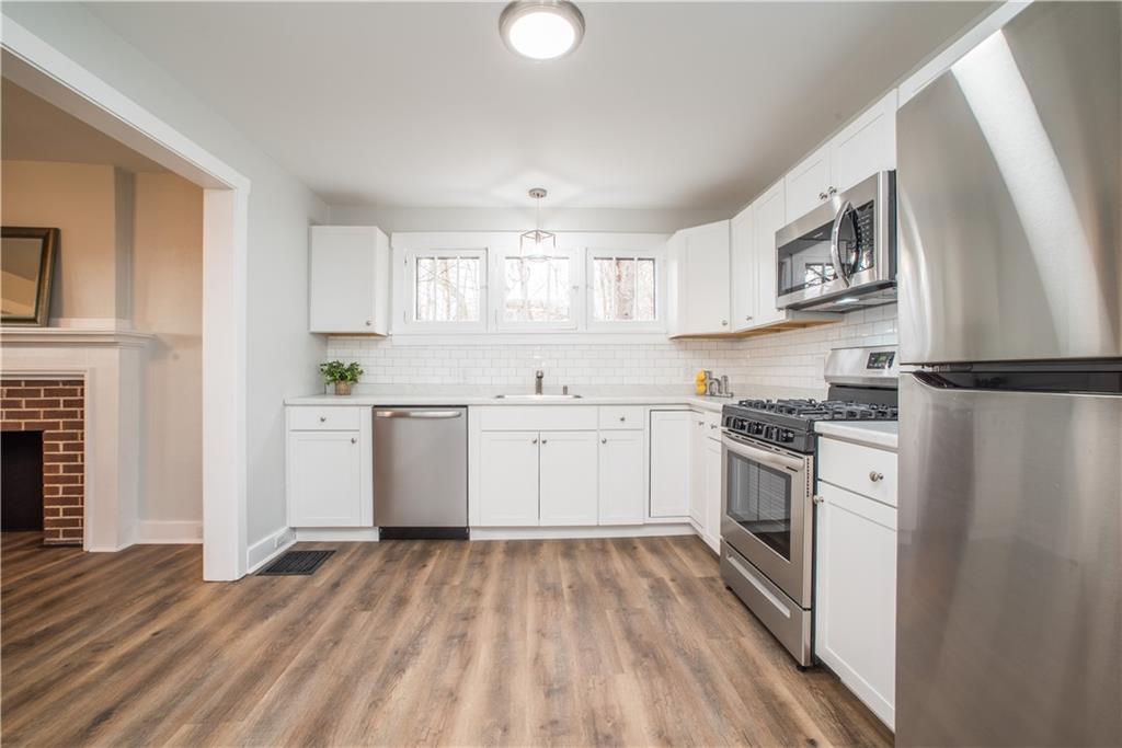 85 Pasadena Street Pittsburgh, PA 15211 - Photo 11 of 25 a kitchen with white cabinets and stainless steel appliances