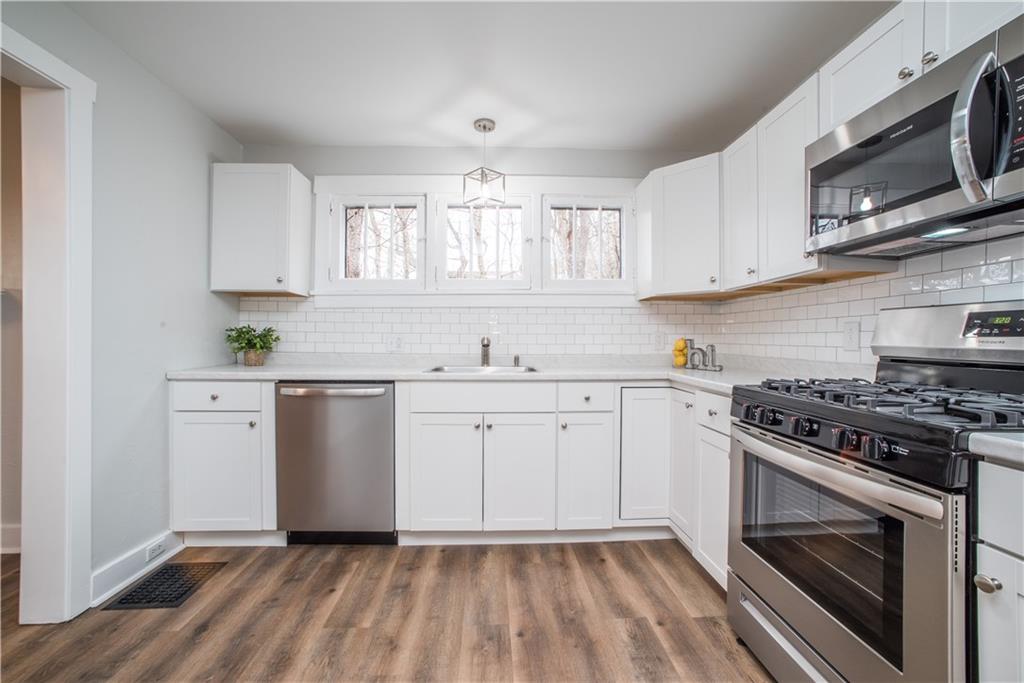 85 Pasadena Street Pittsburgh, PA 15211 - Photo 13 of 25 a kitchen with granite countertop white cabinets stainless steel appliances and sink
