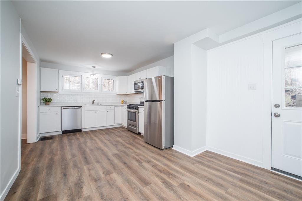 85 Pasadena Street Pittsburgh, PA 15211 - Photo 14 of 25 a kitchen with stainless steel appliances a refrigerator sink and cabinets