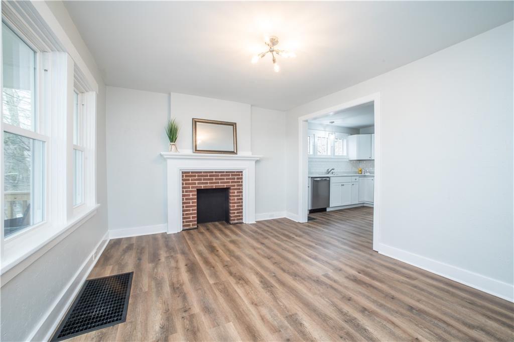 85 Pasadena Street Pittsburgh, PA 15211 - Photo 5 of 25 a view of empty room with wooden floor and fireplace