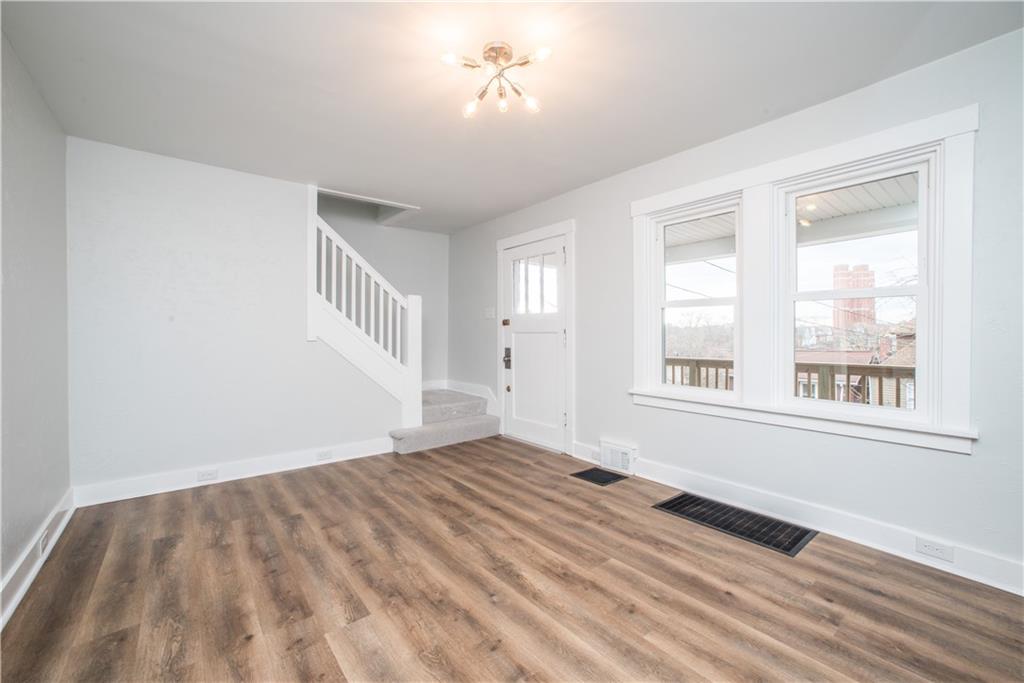 85 Pasadena Street Pittsburgh, PA 15211 - Photo 6 of 25 a view of an empty room with a window and wooden floor