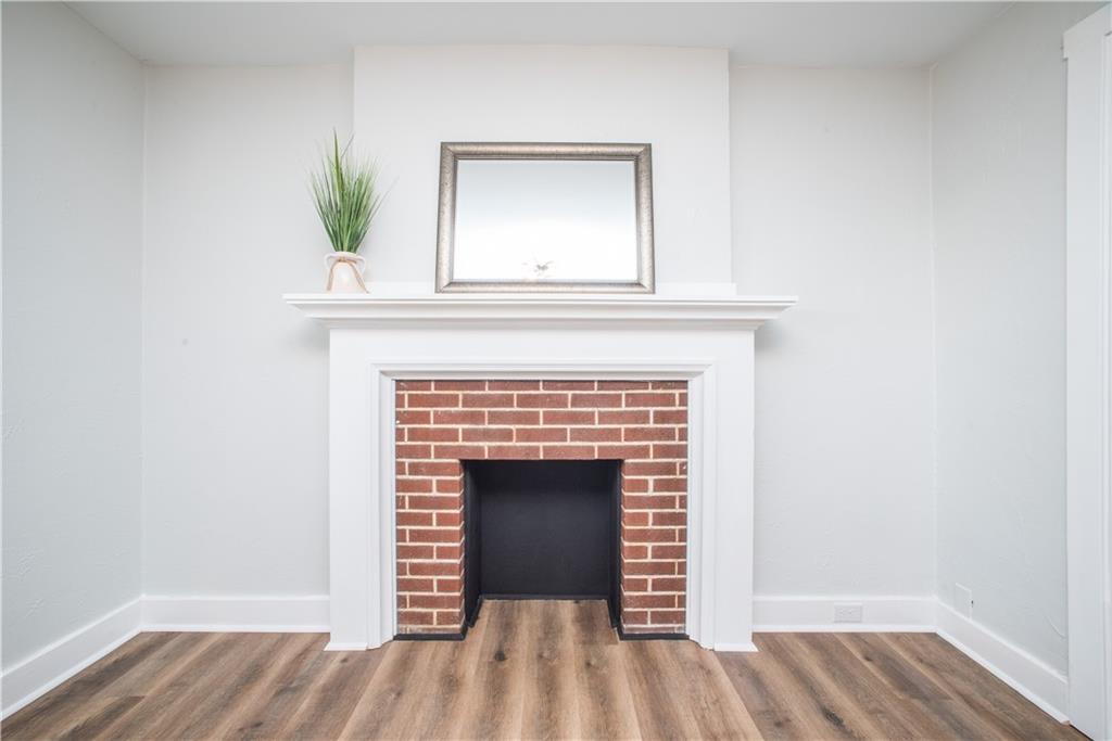 85 Pasadena Street Pittsburgh, PA 15211 - Photo 8 of 25 a view of empty room with wooden floor and fireplace