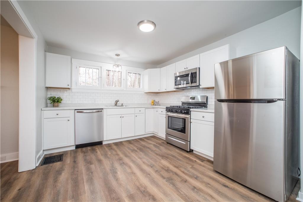85 Pasadena Street Pittsburgh, PA 15211 - Photo 9 of 25 a kitchen with white cabinets and white appliances