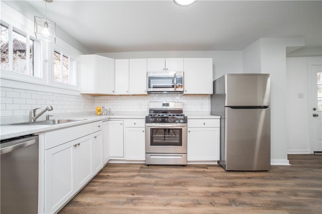 85 Pasadena Street Pittsburgh, PA 15211 - Photo 10 of 25 a kitchen with a white cabinets and white appliances