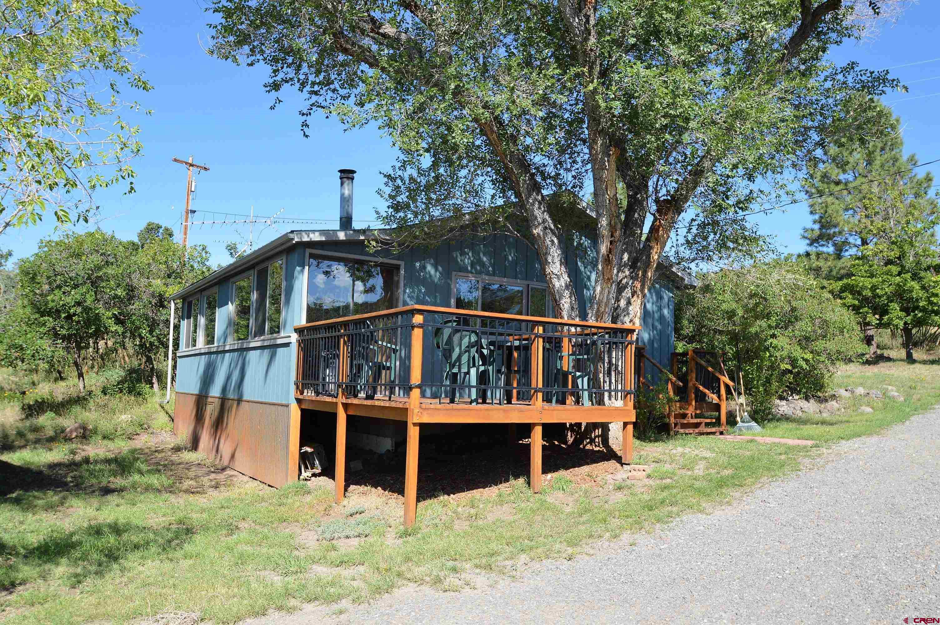 21939-21951 2225 Road Cedaredge, CO 81413 - Photo 27 of 35 front view of a house with a yard